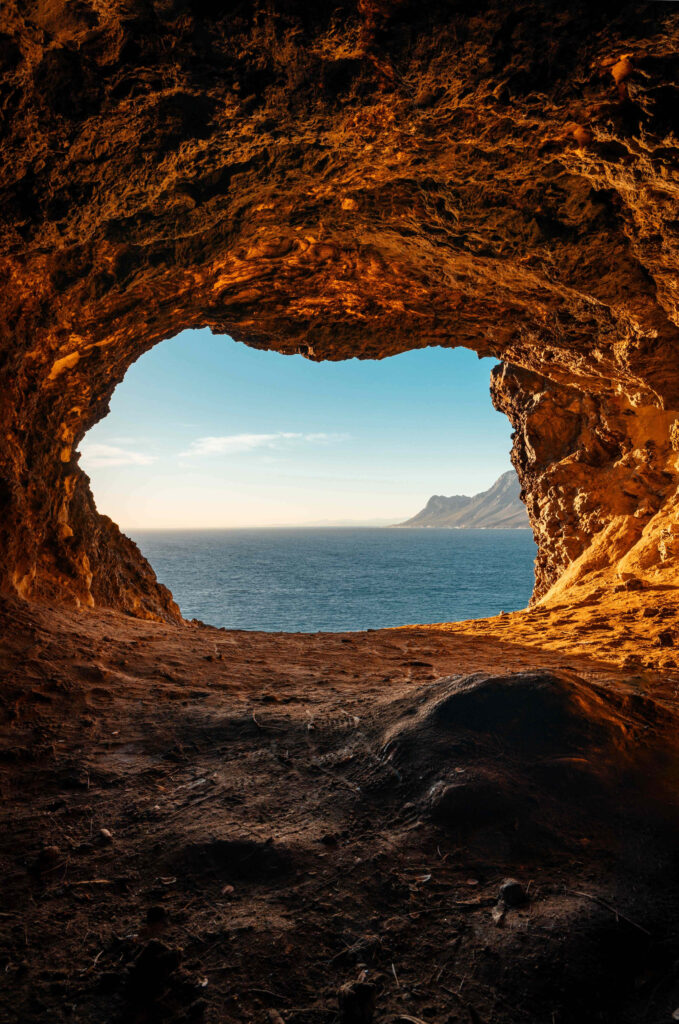 Serene Seascape from a Rocky Cave - Stunning Adventure Background Wallpaper