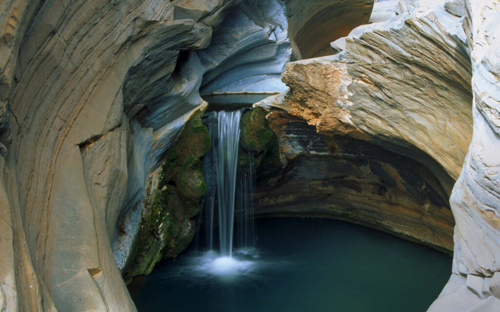Breathtaking Cave Waterfall Wallpaper - Majestic Tranquility Background