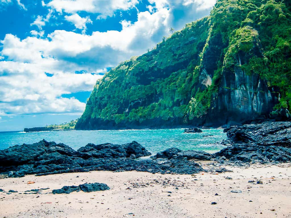 Tropical Cliffside Wallpaper: Lush Comoros Islands Beach Scene
