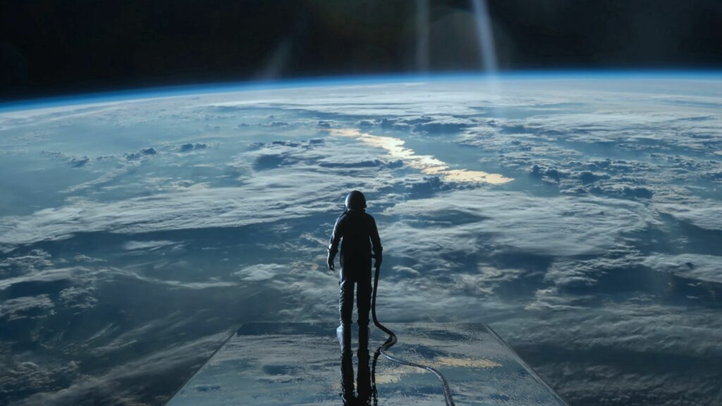 Breathtaking Cosmonaut Wallpaper: Gazing at a Glowing Planet's Surface