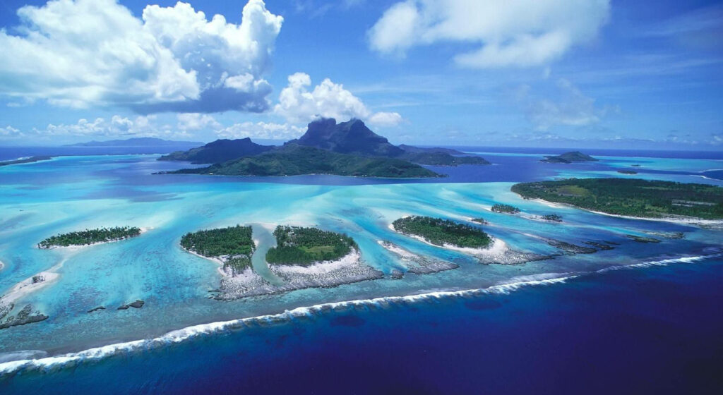 Aerial view of Fiji islands turquoise waters lush green mountains tropical paradise wallpaper