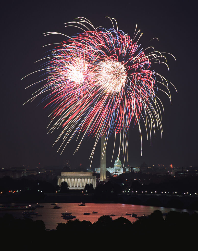 Vibrant Cityscape Fireworks Wallpaper – Festive Night Sky Background