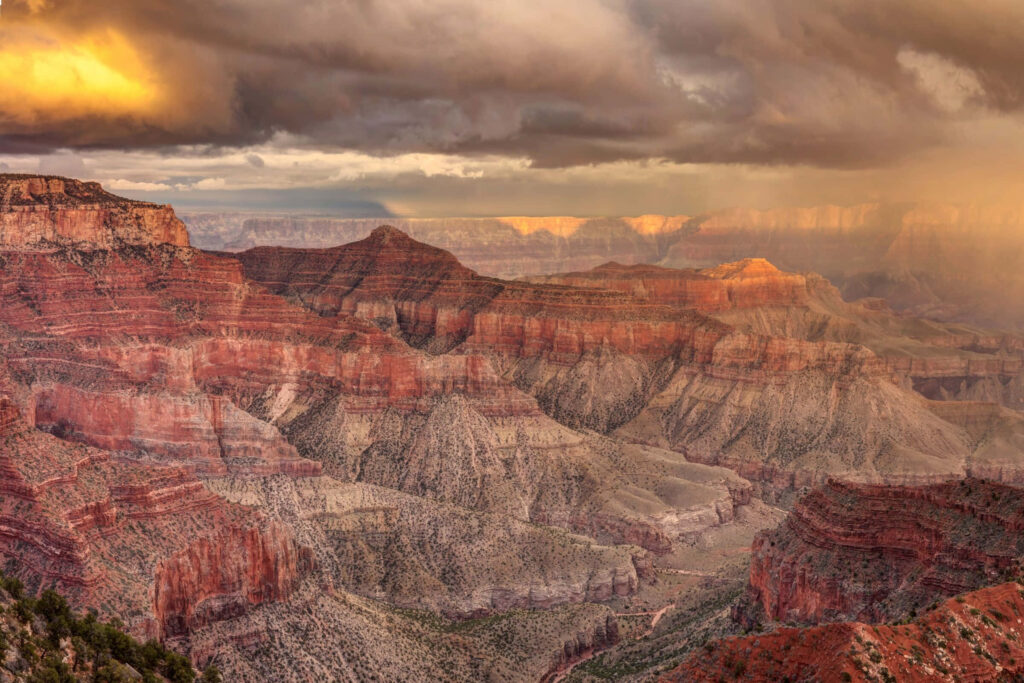 Breathtaking Grand Canyon View: Red Rock Layers & Dramatic Sky Wallpaper