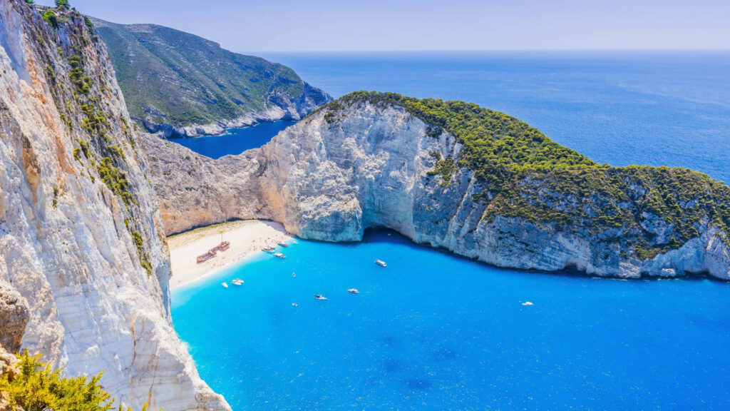 Breathtaking Greece Beach Wallpaper: Cliffs & Crystal-Clear Water