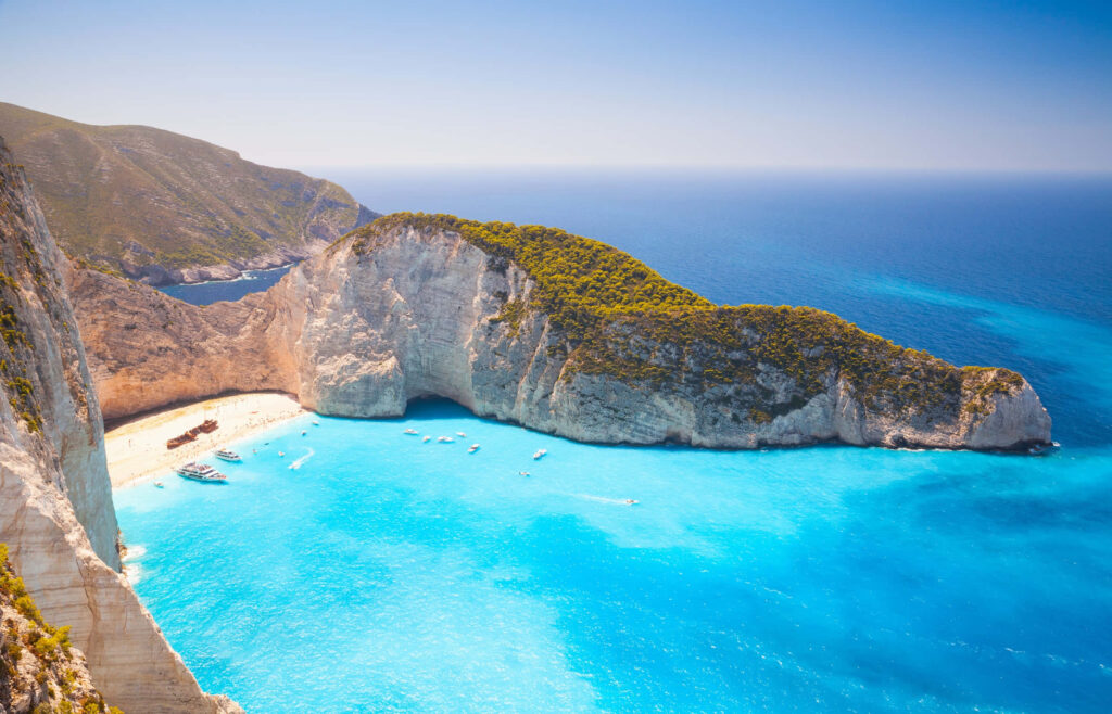 Stunning Greek Beach Wallpaper: Turquoise Waters & Dramatic Cliffs