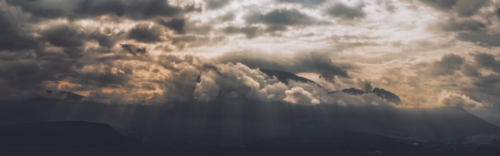 Dramatic Mountain Peaks HD Wallpaper with Ethereal Cloud Glow