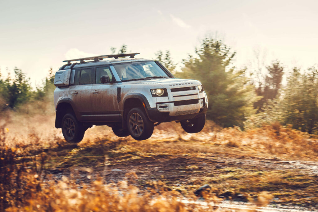 Stunning Land Rover Defender Off-Road Wallpaper in Scenic Wilderness