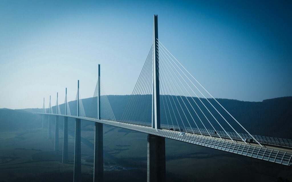 Stunning Cable-Stayed Bridge Wallpaper Over Serene Valley & River