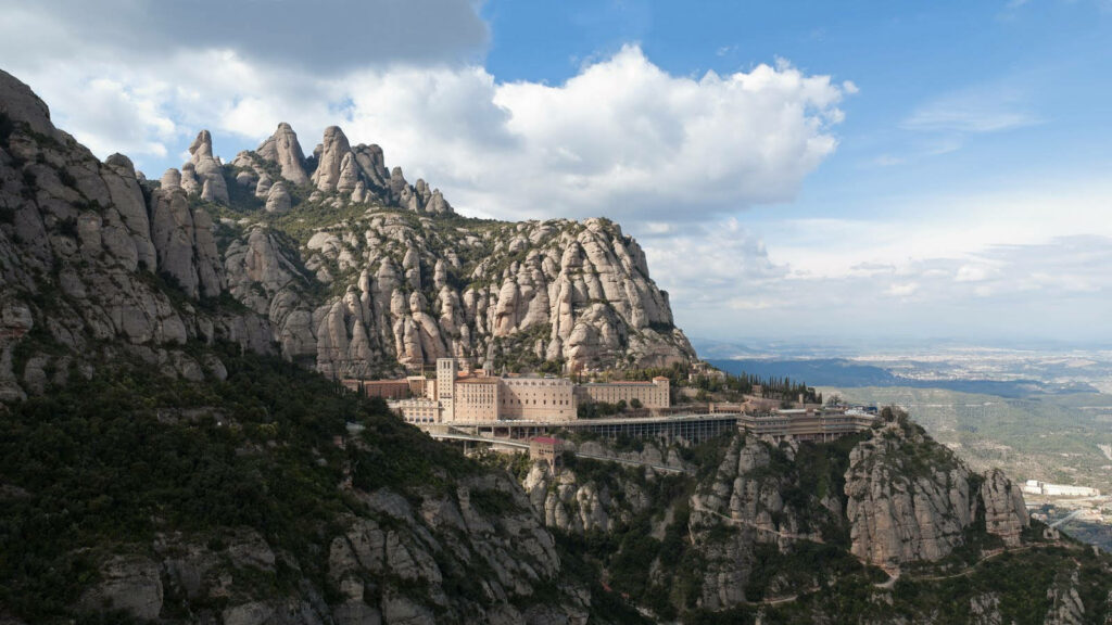 Breathtaking Montserrat View: Medieval Architecture & Rugged Peaks Wallpaper