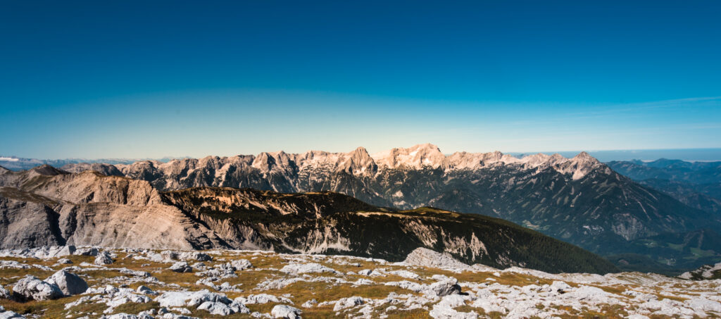 Breathtaking mountain landscape wallpaper with rugged rocks dramatic horizon and clear blue sky
