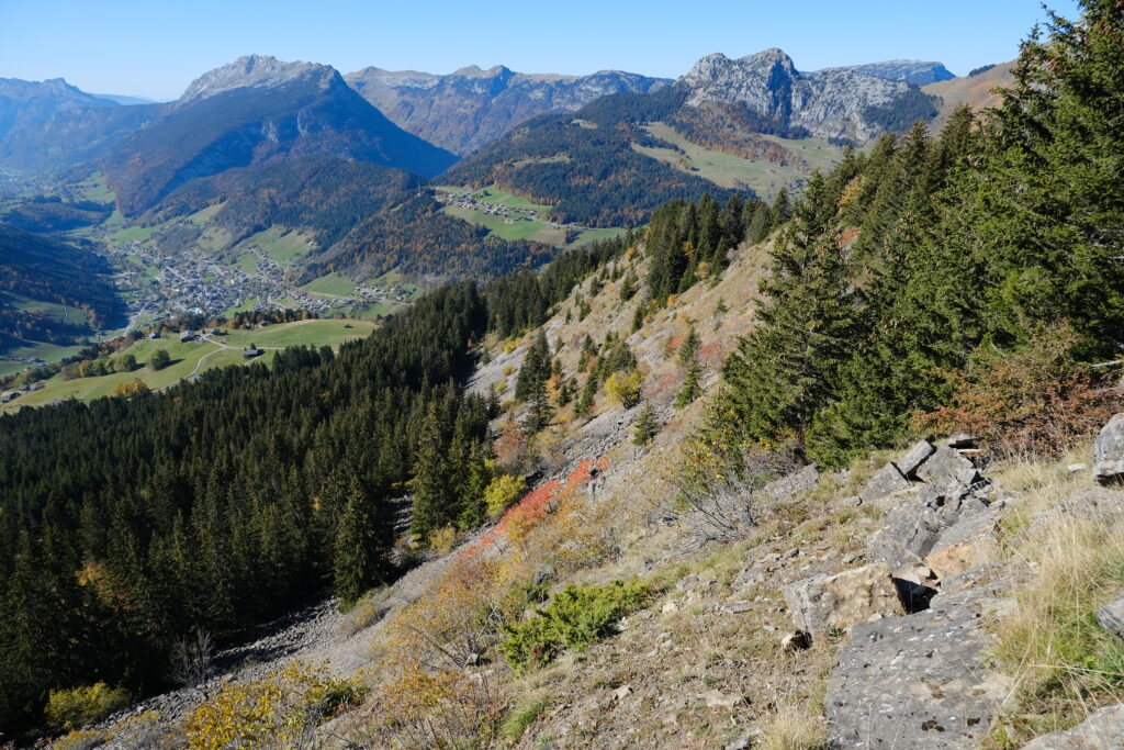 Breathtaking mountain landscape with rocky slopes lush green trees and autumn foliage wallpaper