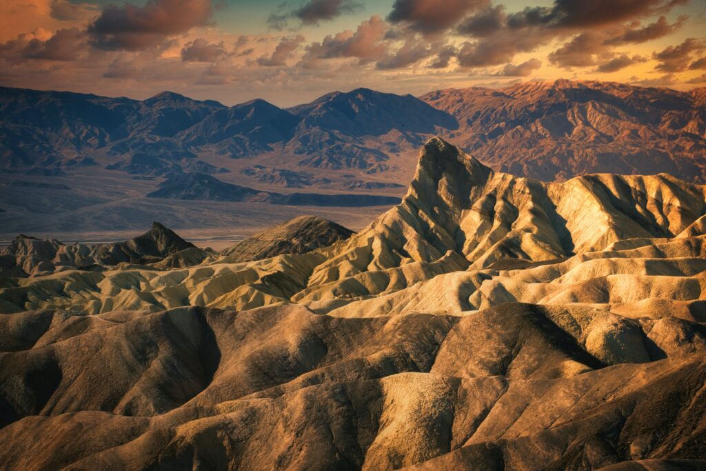 Breathtaking mountain landscape with rugged rocks and golden sunset sky wallpaper background