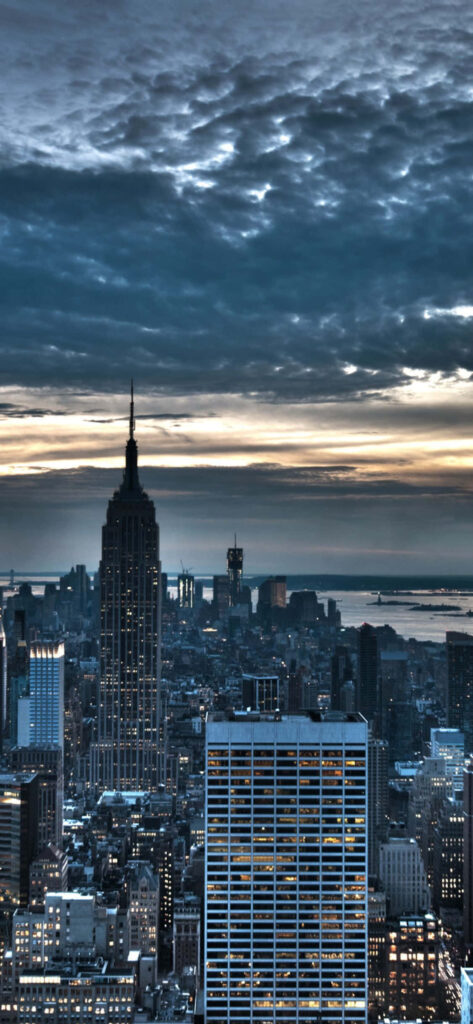 Breathtaking NYC Night Skyline Wallpaper: Iconic Architecture & Clouds