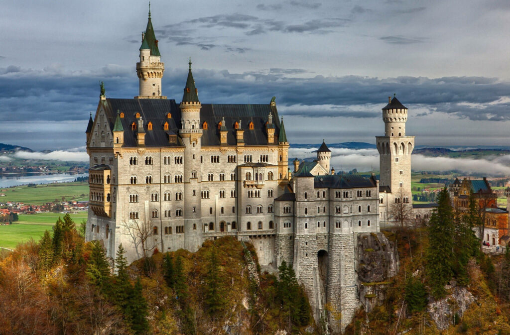 Neuschwanstein Castle Wallpaper: Fairytale View Amidst Brown Trees