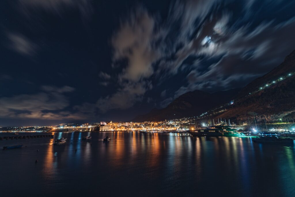 Serene Nighttime Cityscape Wallpaper: Waterfront & Glimmering Lights