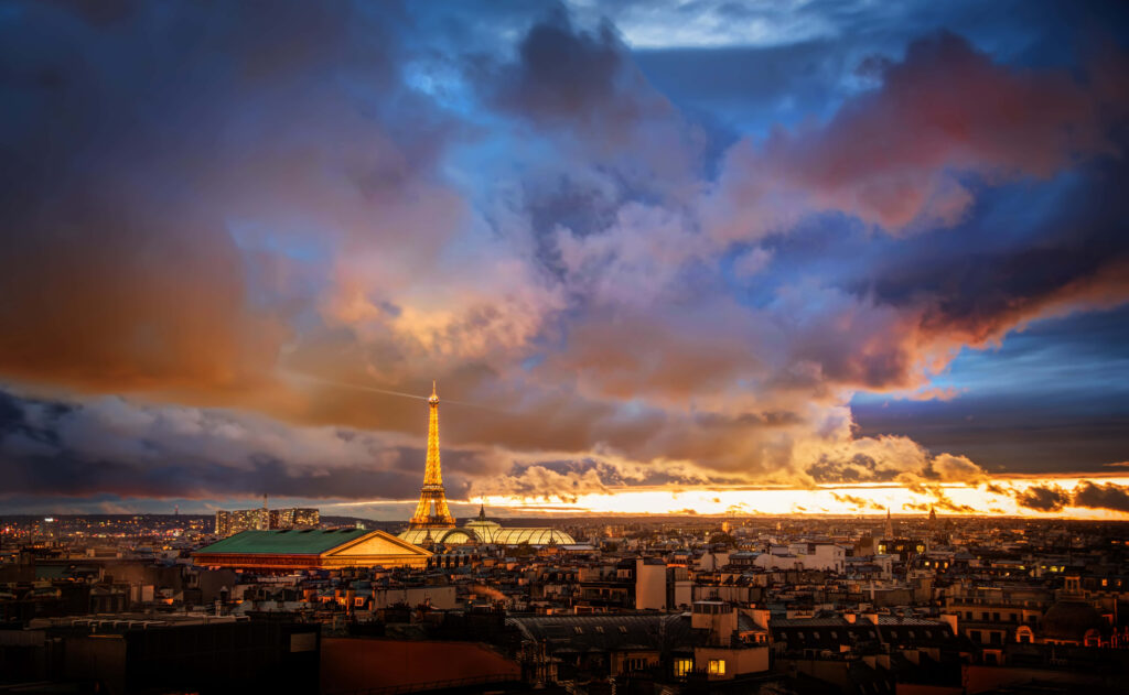 Breathtaking Paris Night Wallpaper: Eiffel Tower & Dramatic Clouds