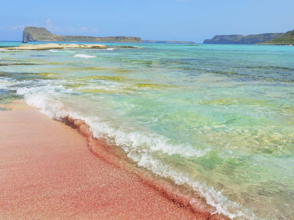 Breathtaking Pink Sand Beach Wallpaper: Serene Coastal Scene