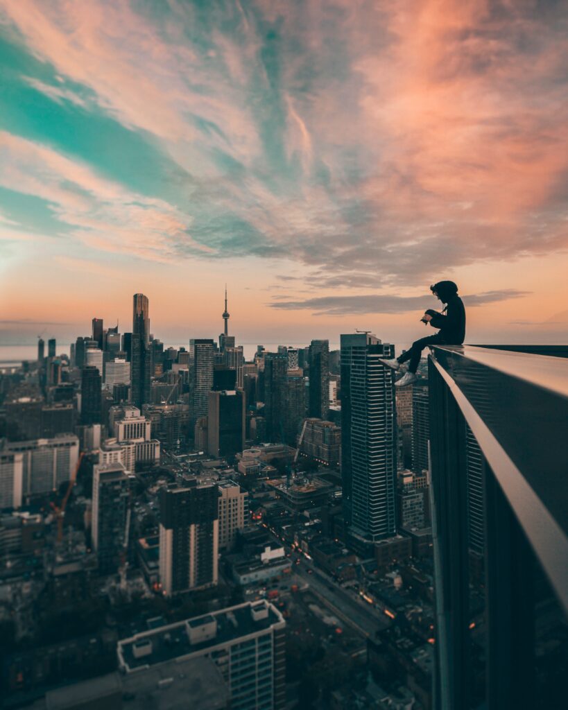 Serene Rooftop View Wallpaper: Man Overlooking City at Sunset