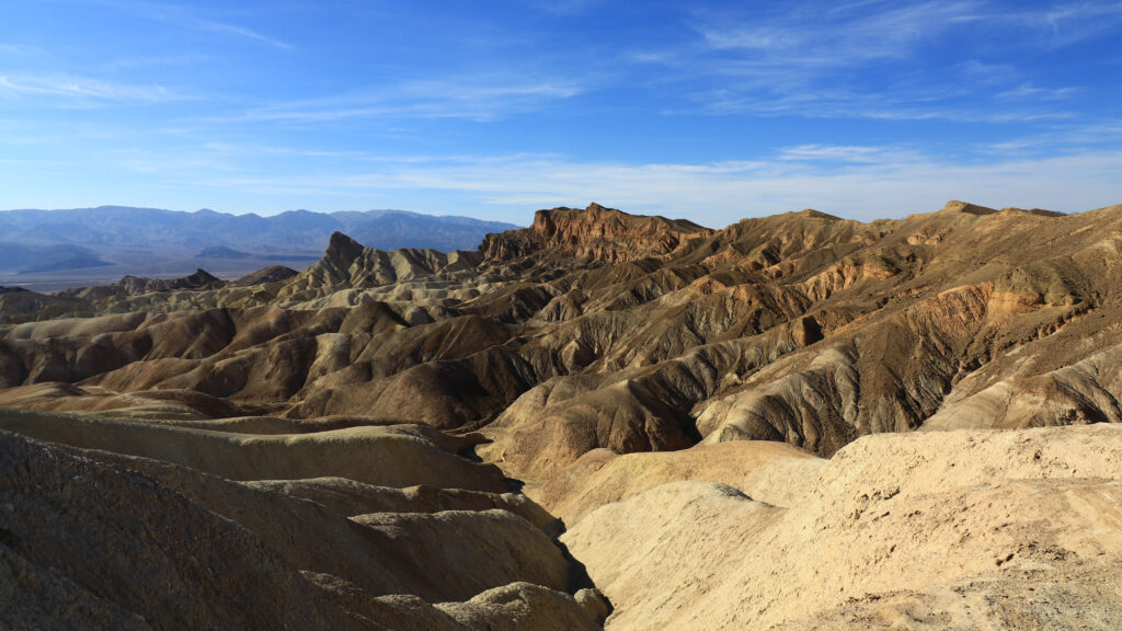 Rugged mountain landscape with dramatic peaks under vivid blue sky outdoor scenery wallpaper
