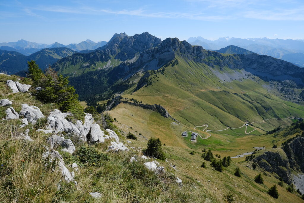 Breathtaking rugged mountains rolling hills clear sky winding road and peaceful natural landscape wallpaper