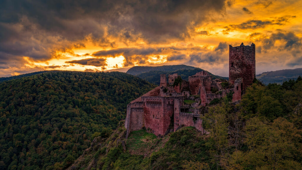 Breathtaking Saint Ulrich Castle Wallpaper: Sunset & Lush Green Forests