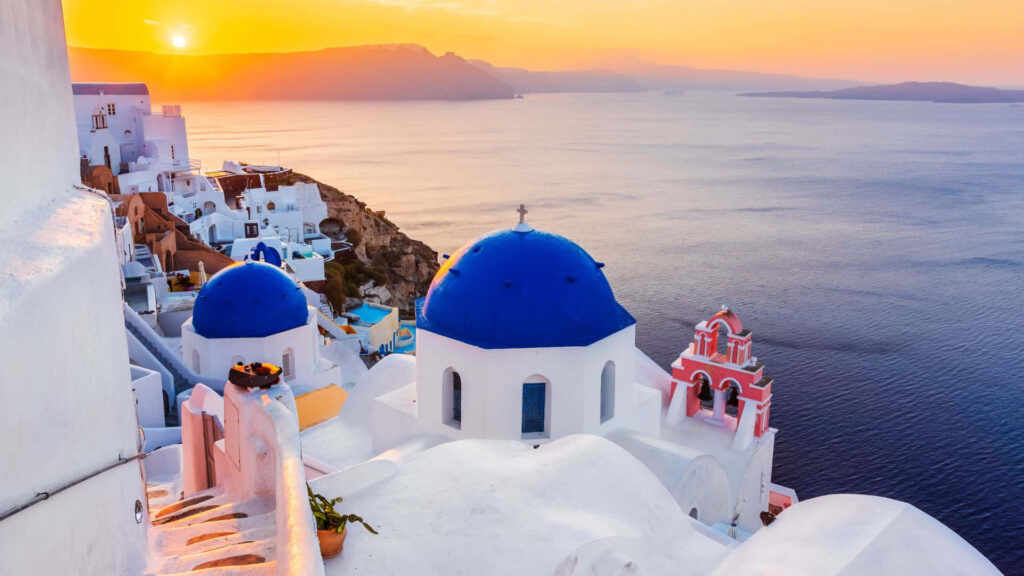 Breathtaking Santorini View: Whitewashed Buildings & Vibrant Sunset Wallpaper