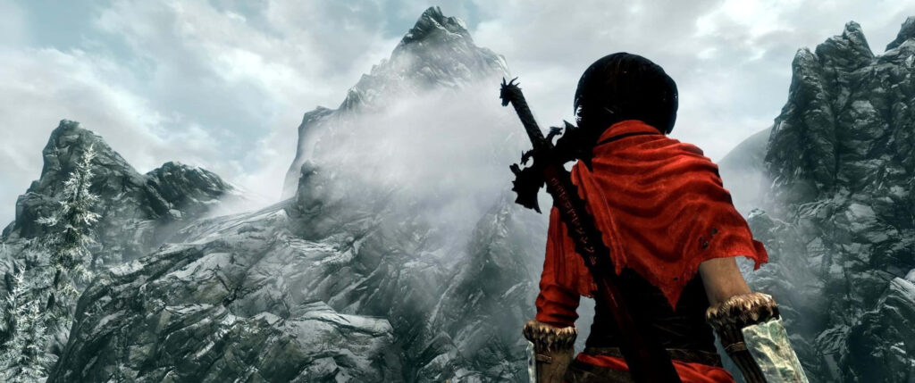 Breathtaking Skyrim Wallpaper: Adventurer in Rugged Mountainscape