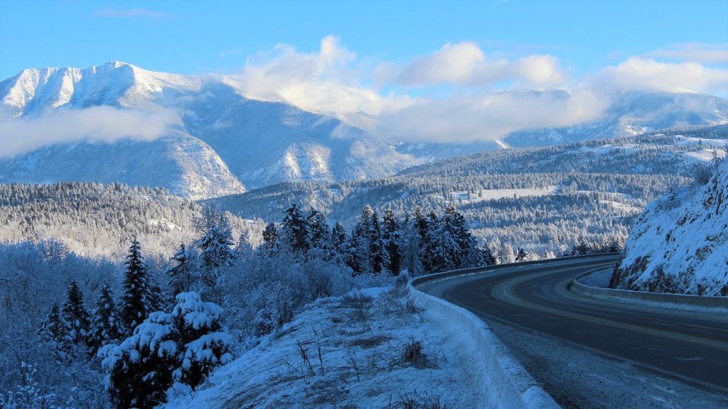 Snow Mountain Range Pass with winding road forest frost trees and snow-capped peaks winter wallpaper