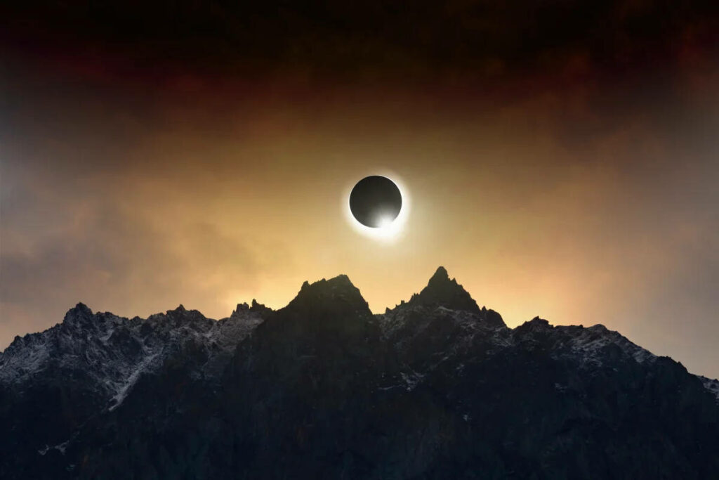 Surreal Solar Eclipse Wallpaper Over Dramatic Cloudy Mountaintop