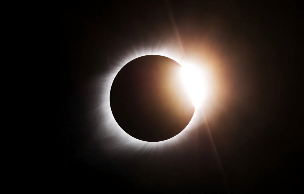 Breathtaking solar eclipse wallpaper showing sun corona glowing around dark moon silhouette