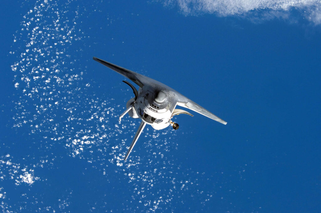 Stunning Space Shuttle Wallpaper: Blue Sky & Clouds Background