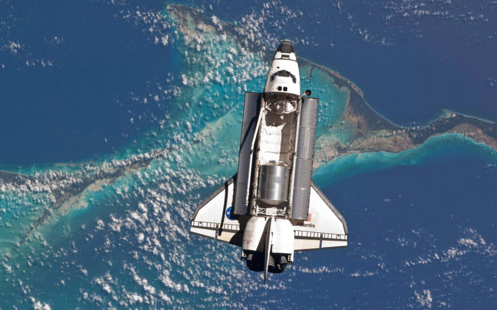 Stunning Space Shuttle Wallpaper: Earth from Above with Blue Waters