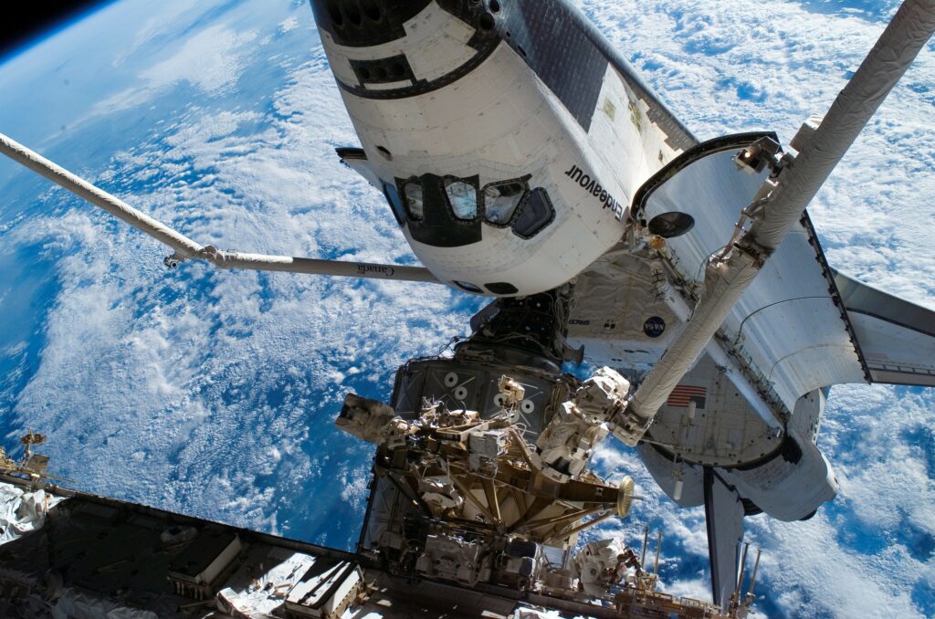 Breathtaking Space Wallpaper: Endeavour & Earth's Beauty Below