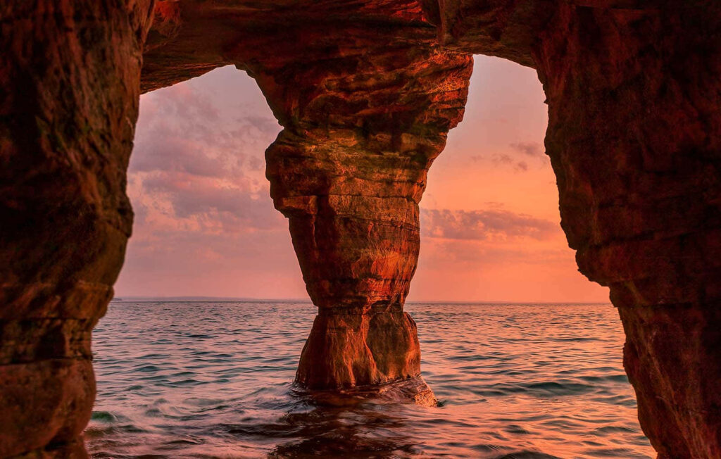 Breathtaking Sunset Over Sea Cave – Serene Scenic Wallpaper