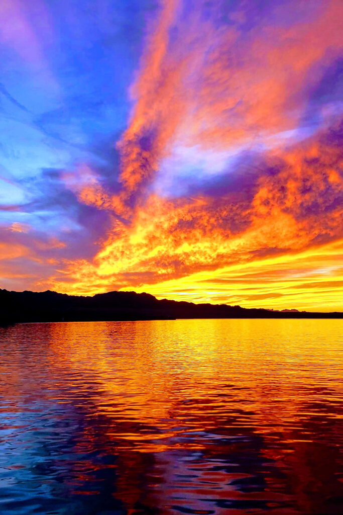 Vibrant Sunset Reflection: Serene Hues Over Calm Waters Wallpaper