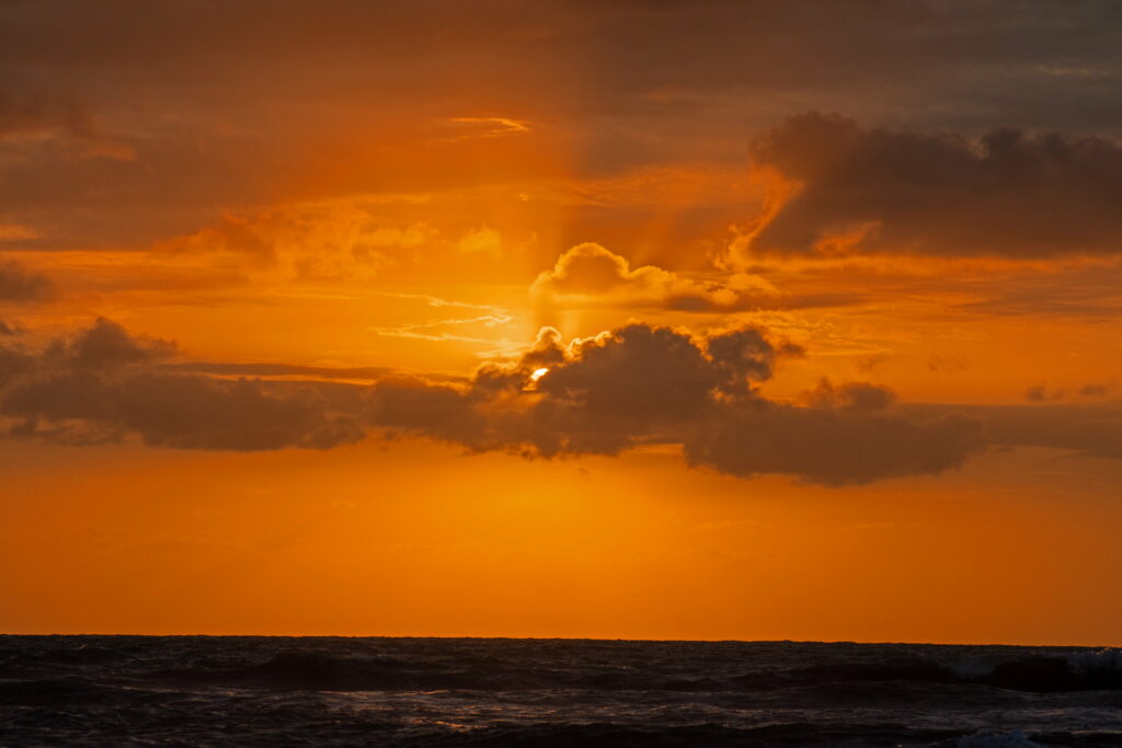 Breathtaking HD Sunset Over Sea: Vibrant Orange & Red Sky Background Wallpaper