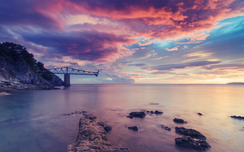 Vivid Sunset Clouds & Calm Waters: HD Wallpaper with Industrial Charm