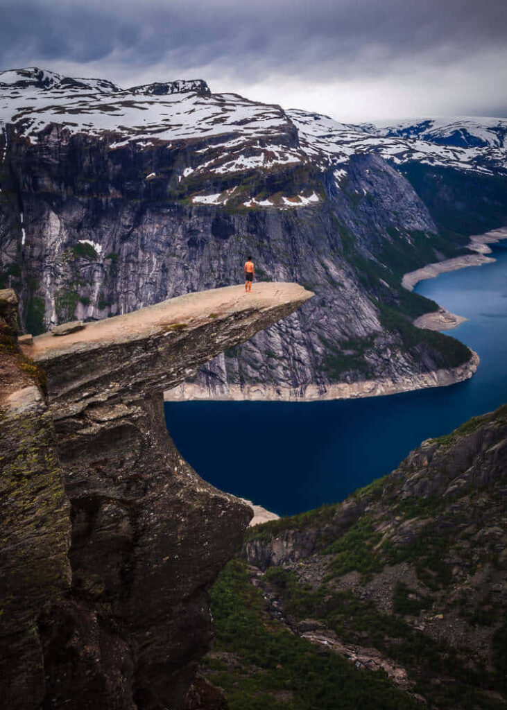 Breathtaking Trolltunga Wallpaper: Adventurer on Cliff in Fjords