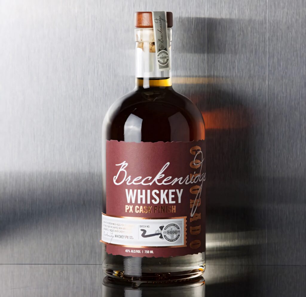Breckenridge Distillery PX Cask Finish Whiskey bottle with maroon label on metallic gray background Wallpaper