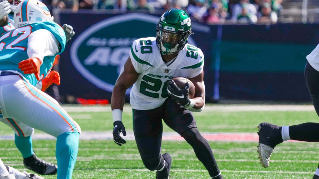 Breece Hall running in New York Jets uniform NFL action wallpaper high resolution athleticism