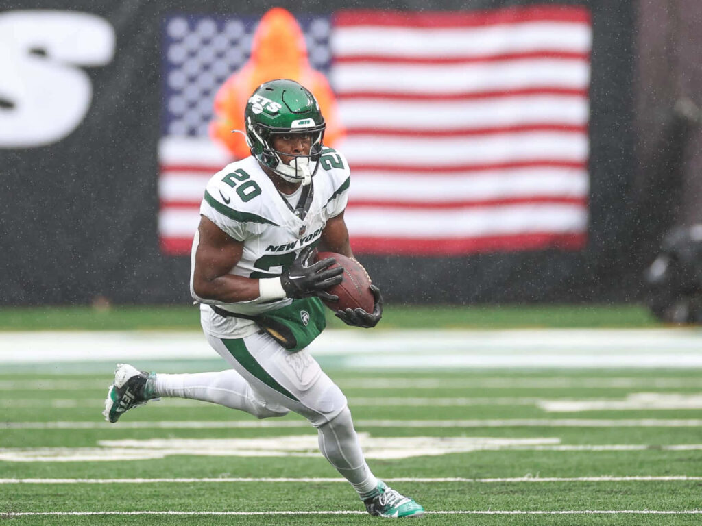 Breece Hall New York Jets running back in action with American flag background wallpaper