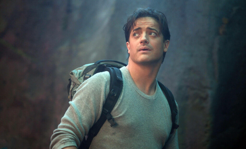 Brendan Fraser adventure movie wallpaper rugged gear backpack dramatic lighting action scene