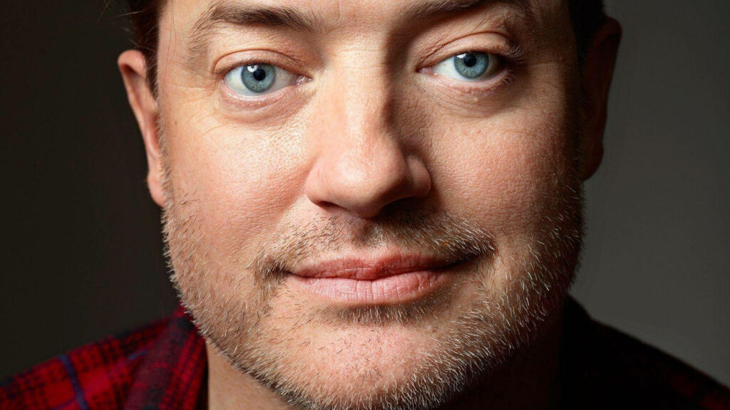 Brendan Fraser close up portrait with expressive blue eyes natural lighting and red plaid shirt Wallpaper