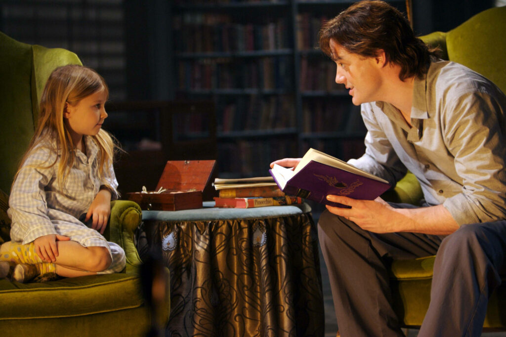 Brendan Fraser and Eliza Bennett in warm library scene from 2008 fantasy film Inkheart wallpaper
