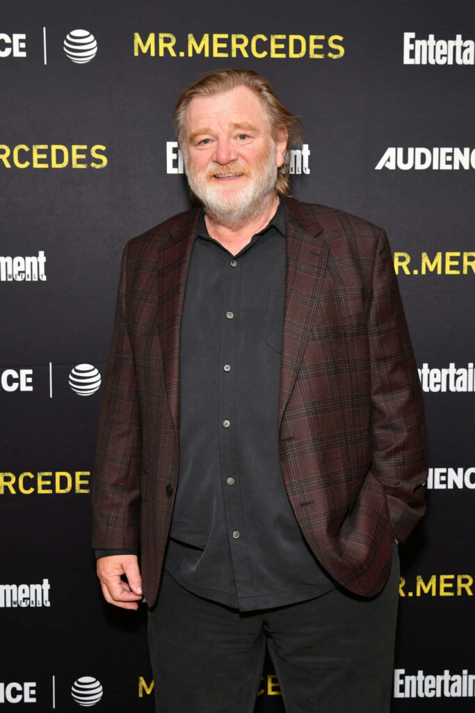 Brendan Gleeson red carpet portrait in checkered blazer at Mr Mercedes event dark background Wallpaper