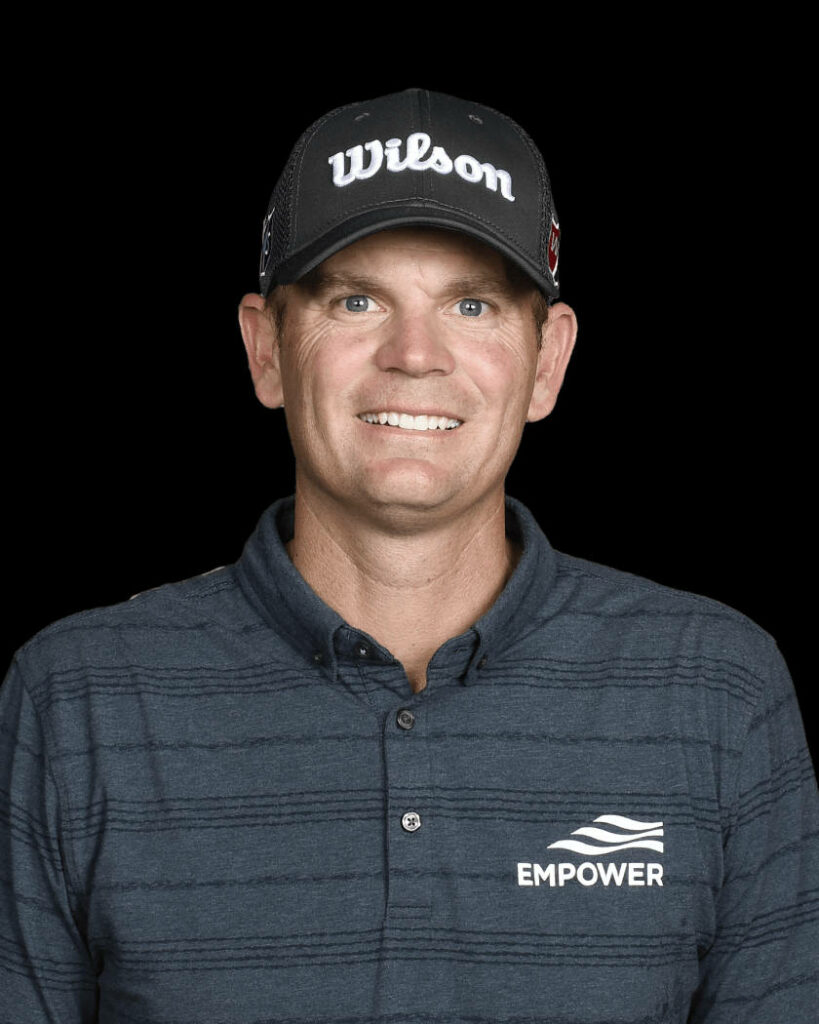 Brendan Steele professional golfer portrait in Wilson cap and Empower polo on black background wallpaper