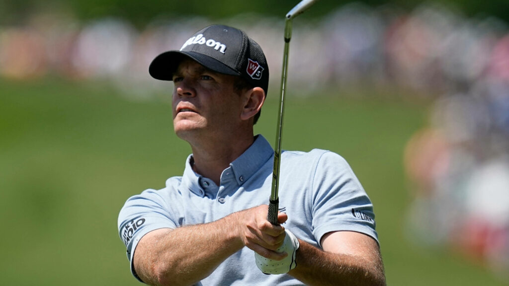 Brendan Steele mid-swing on golf course wearing Wilson cap light blue polo sports wallpaper background