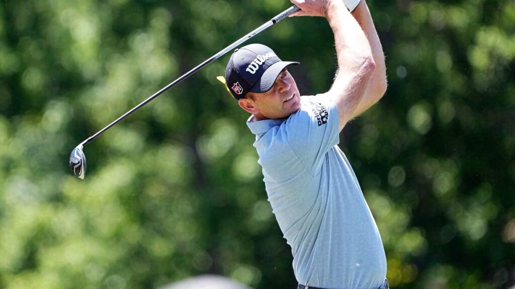 Brendan Steele mid-swing on lush green golf course dynamic professional golf wallpaper