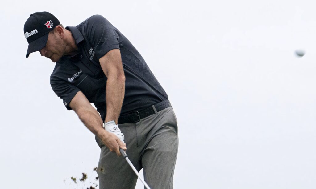 Brendan Steele powerful golf swing mid-shot airborne ball motion blur flying turf wallpaper