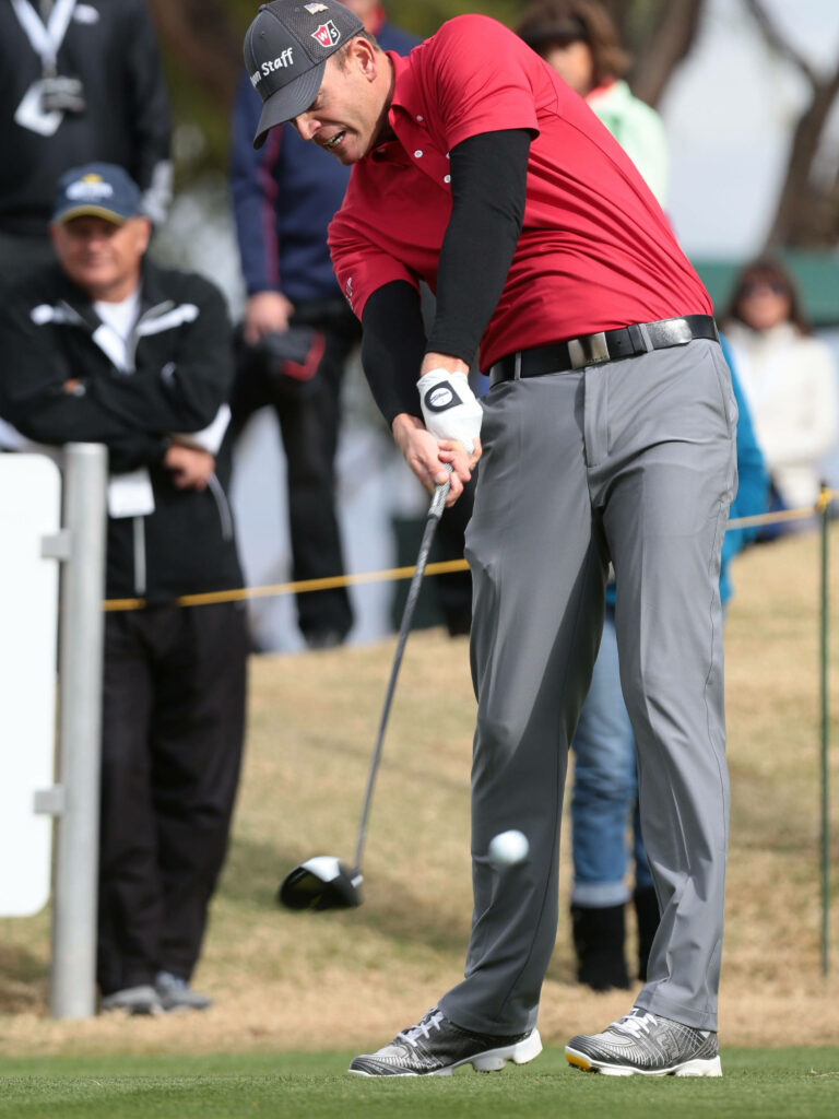 Brendan Steele powerful golf swing red shirt gray pants vibrant golf course wallpaper background